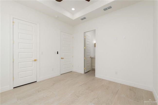 Spacious Secondary Bedrooms with Walk-In ClosetsBoth secondary bedrooms offer generous space, each featuring large walk-in closets and high ceilings that enhance the open, airy feel. | Image 27