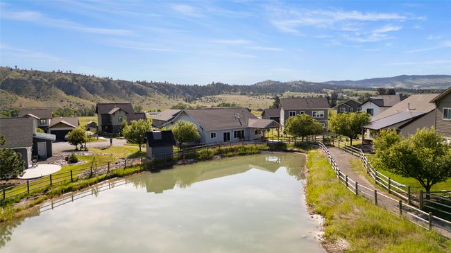 Water view featuring nearby suburban area and a mountainous background | Image 34