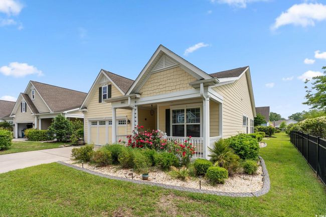 View of front of house featuring covered porch, fence, driveway, and a front yard | Image 33
