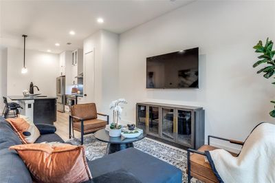 Living room featuring light hardwood / wood-style flooring and sink | Image 1