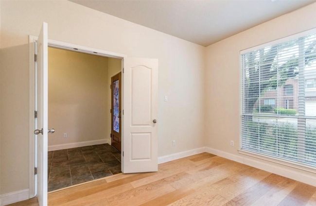 Spare room with baseboards and light wood-style flooring | Image 6