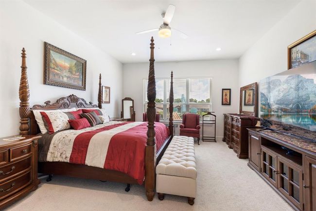 Spacious primary suite with stunning pool and lake views. | Image 26