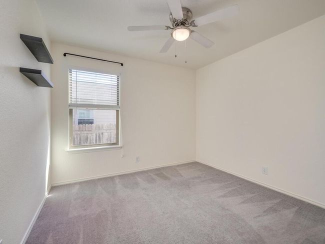 Second bedroom with carpet flooring and a ceiling fan. | Image 20