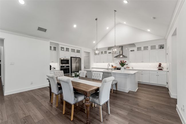 Dining area featuring recessed lighting, high vaulted ceiling, dark wood finished floors, and crown molding | Image 6
