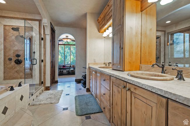 Bathroom featuring a shower stall, double vanity, and a sink | Image 34