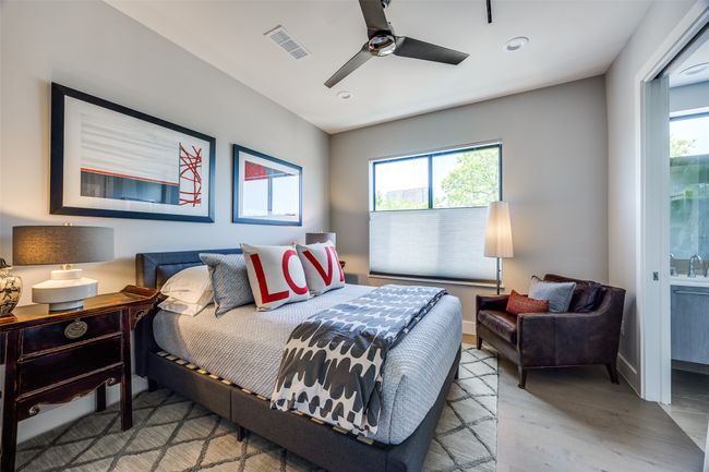 Bedroom featuring wood finished floors, multiple windows, visible vents, and recessed lighting | Image 27