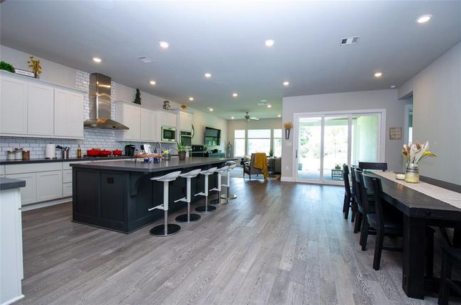 Bright and open main living areas with views out to the backyard. | Image 4
