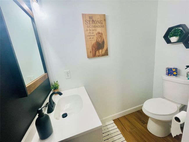 Half bathroom with wood finished floors, vanity, and toilet | Image 19