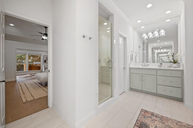 Bathroom with ensuite bath, vanity, a shower stall, ornamental molding, and a ceiling fan | Image 18
