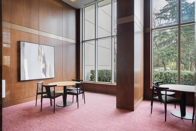 Carpeted dining room with a towering ceiling, wooden walls, and expansive windows | Image 25