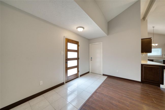 Beautiful entry with mid-century style door where to your left is garage entry and right will be your coat closet | Image 5