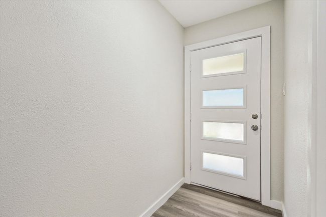 Doorway with baseboards and light wood-style floors | Image 5