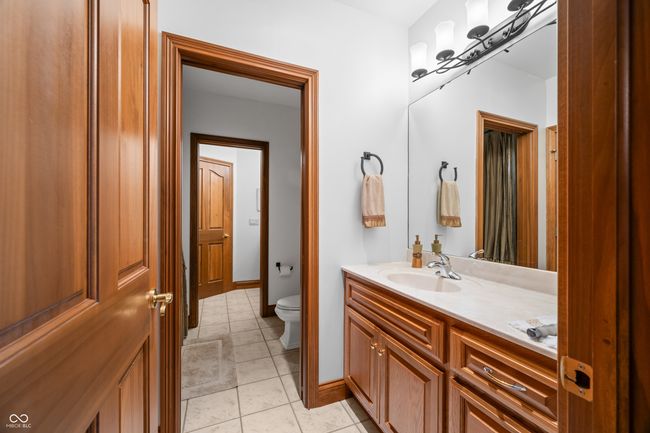 bathroom with baseboards, toilet, tile patterned flooring, and vanity | Image 90