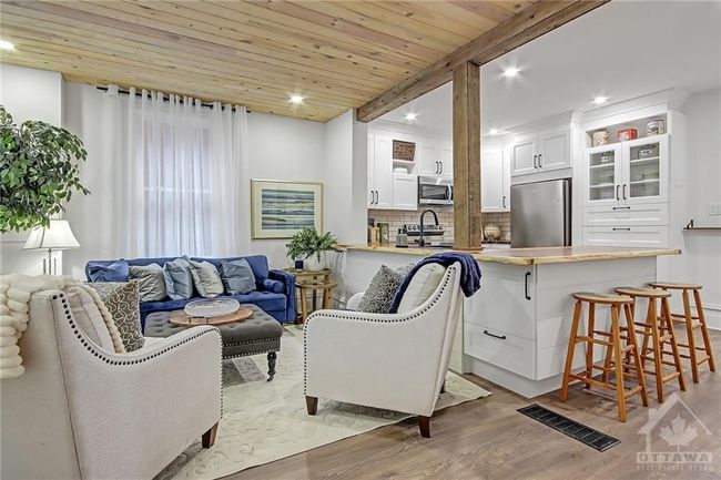 Well lit Living room with custom tong and grove white washed pine ceiling | Image 4