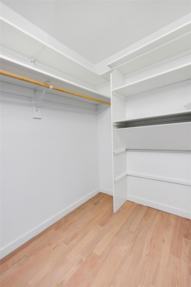 Spacious closet with hardwood / wood-style flooring | Image 47