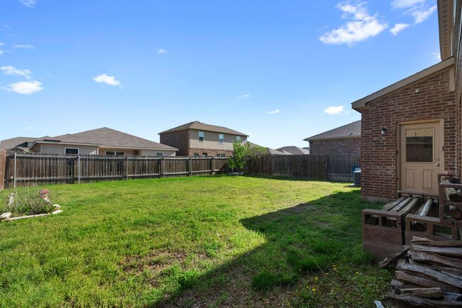 View of yard featuring a fenced backyard and central AC unit | Image 35