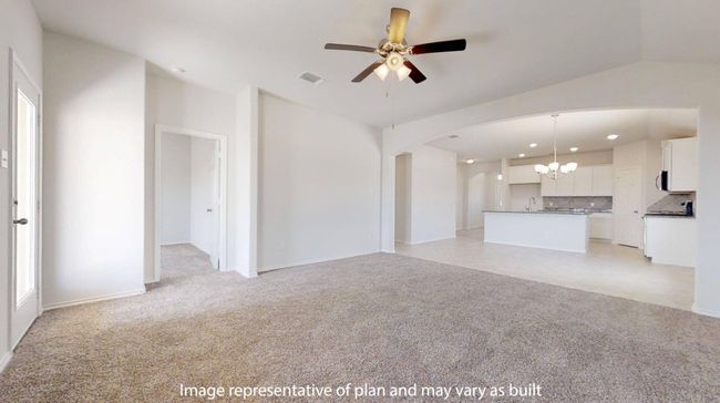 Unfurnished living room with a chandelier, light carpet, ceiling fan, and arched walkways | Image 11