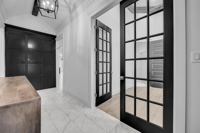 Foyer entrance with marble finish floor, a decorative wall, vaulted ceiling, and crown molding | Image 10