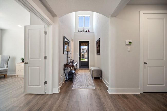 Foyer featuring arched walkways and wood finished floors | Image 8