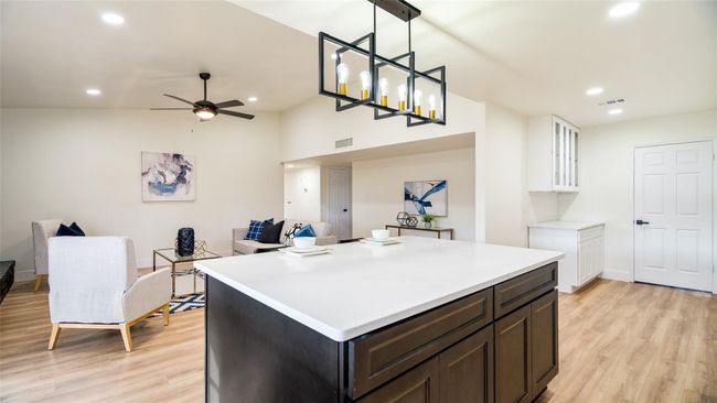Kitchen featuring open floor plan, light wood finished floors, ceiling fan, and visible vents | Image 13