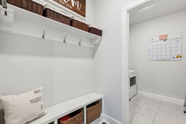 Mudroom with light tile patterned floors, washer / clothes dryer, and baseboards | Image 18