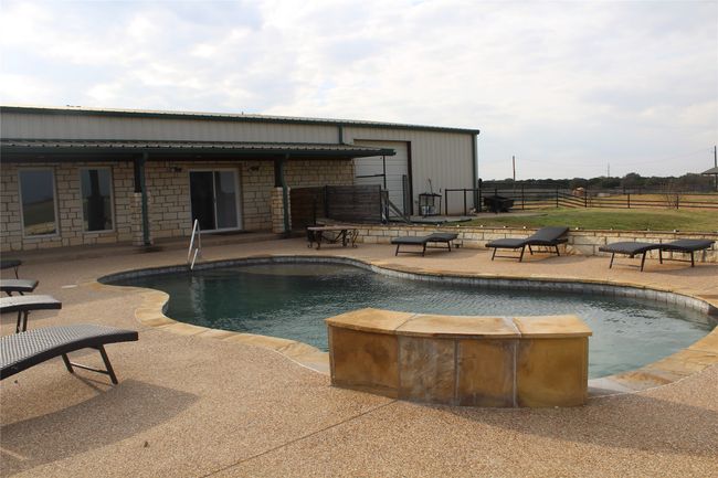 Outdoor pool with a patio and fence | Image 19
