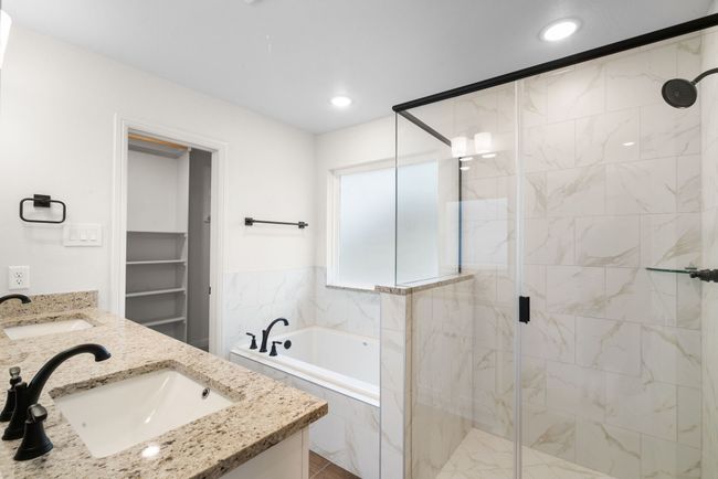 Bathroom featuring shower with separate bathtub and vanity | Image 15