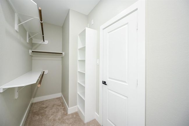 Walk-In Closet Has Built-In Shelving & A Window To Let In Natural Sunlight | Image 27