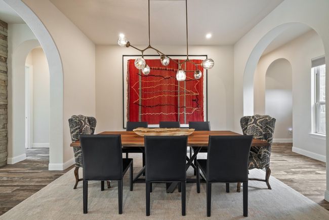 Dining room featuring wood finished floors, baseboards, arched walkways, and recessed lighting | Image 16