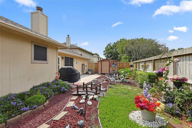 Like-new storage shed offers endless possibilities — use it for extra storage, a private home office, or a cozy she shed. All set within a beautifully landscaped backyard designed for both function and relaxation. | Image 20