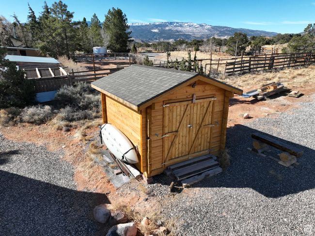 View of shed with a mountain view and fence | Image 26
