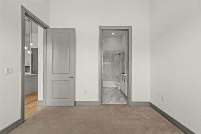 Unfurnished bedroom with baseboards, carpet, and ensuite bathroom | Image 16