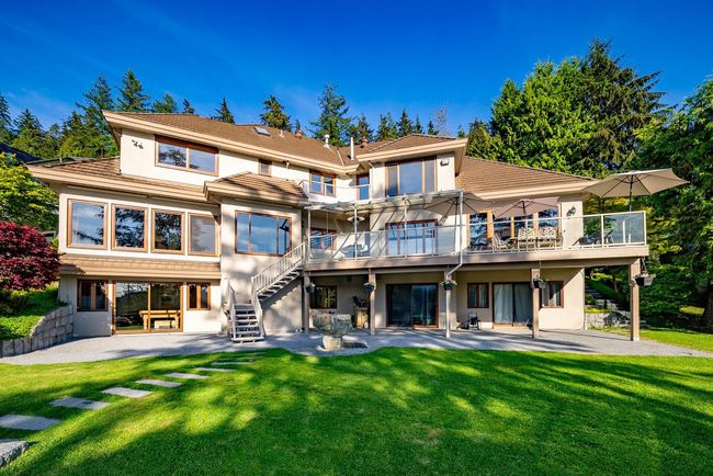 Back of property with a yard, a patio, and stucco siding | Image 32