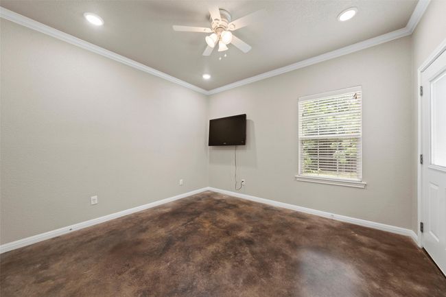 Unfurnished room featuring ceiling fan, ornamental molding, recessed lighting, and concrete floors | Image 10