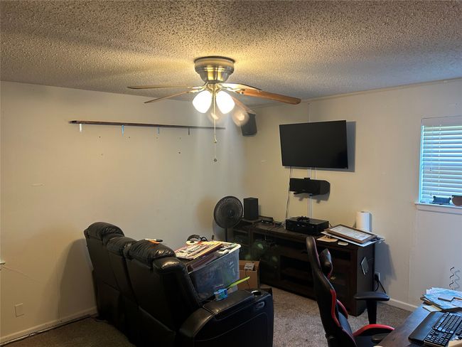 Office featuring a ceiling fan, carpet floors, a textured ceiling, and baseboards | Image 12
