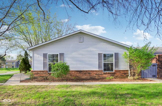 view of side of property featuring brick siding and a lawn | Image 24