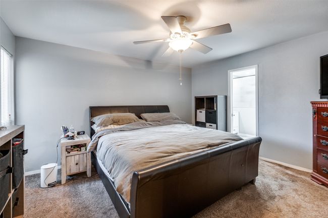 Carpeted bedroom with baseboards and a ceiling fan | Image 13