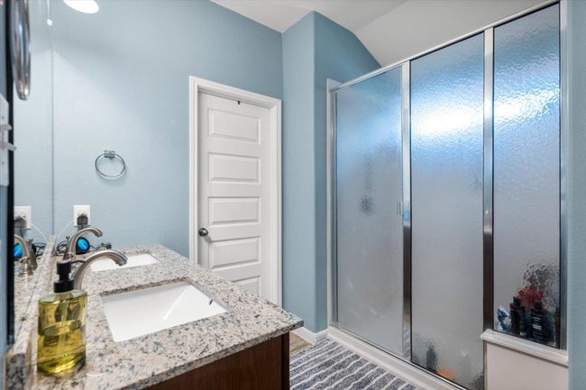 Bathroom featuring double vanity and a walk in shower | Image 18