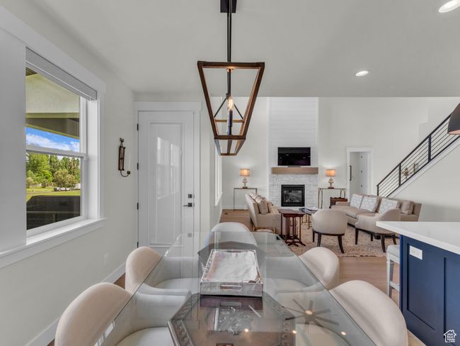 Living area featuring a fireplace, baseboards, wood finished floors, and recessed lighting | Image 18