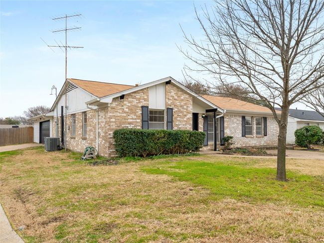 Single story home featuring central AC, a garage, and a front lawn | Image 31