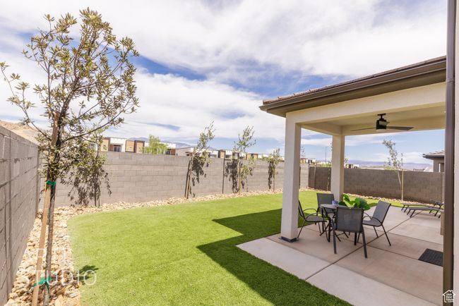 View of yard with a ceiling fan, a patio area, and a fenced backyard | Image 36