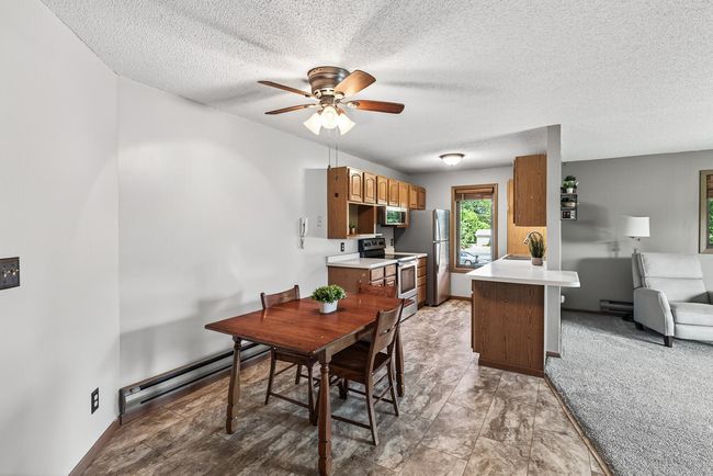 Here is an alternate view of the kitchen, dining room, and a peek into the living room. | Image 4
