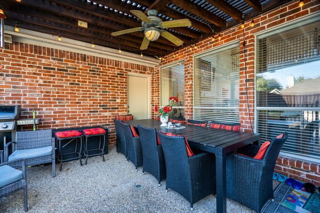 View of patio with outdoor dining area and ceiling fan | Image 32