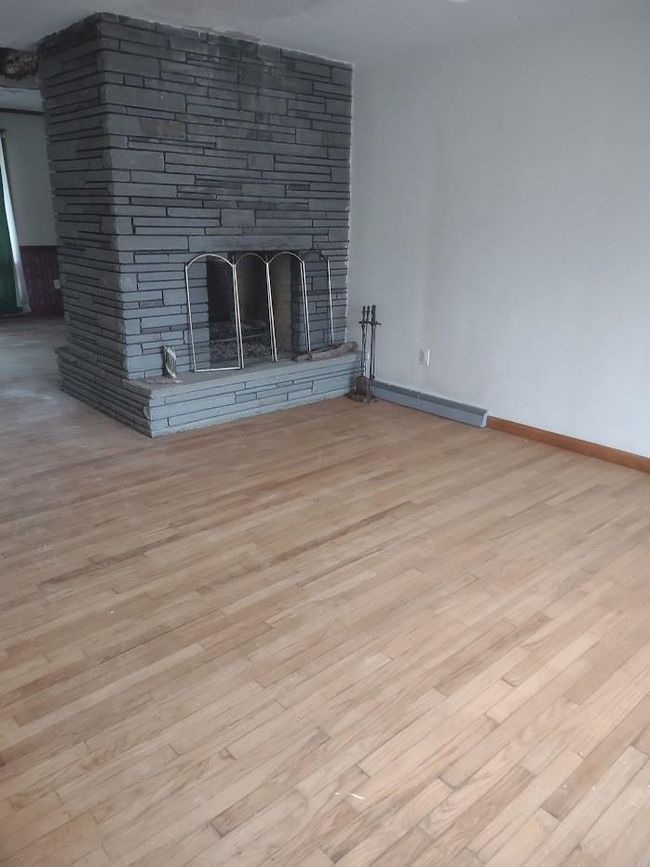 Unfurnished living room featuring a fireplace and light wood-type flooring | Image 7