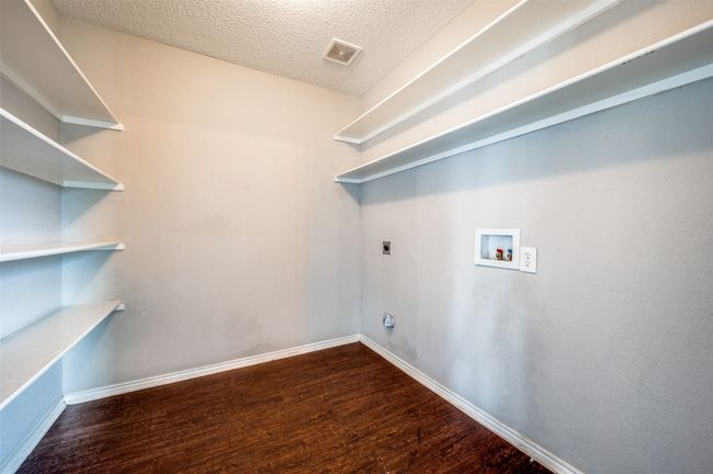 Laundry room with hookup for a washing machine, wood finished floors, hookup for an electric dryer, baseboards, and a textured ceiling | Image 19