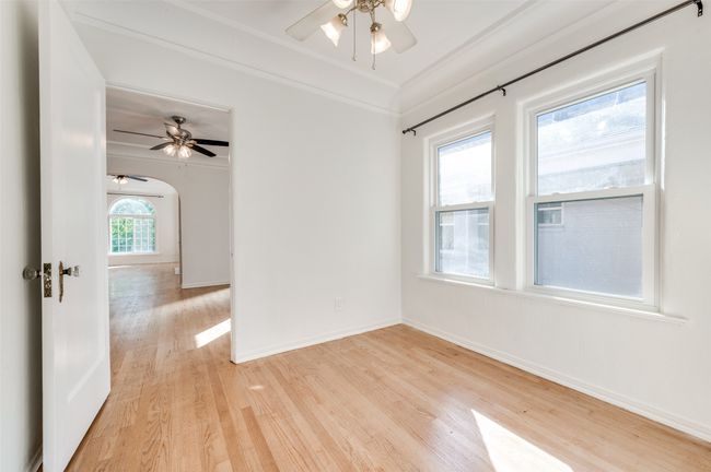 Spare room with light wood-type flooring, ceiling fan, baseboards, and crown molding | Image 26