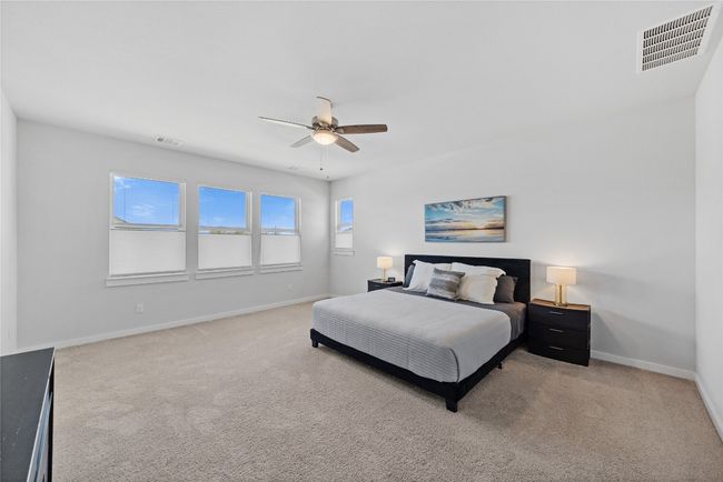 Bedroom with light carpet, baseboards, visible vents, and ceiling fan | Image 15