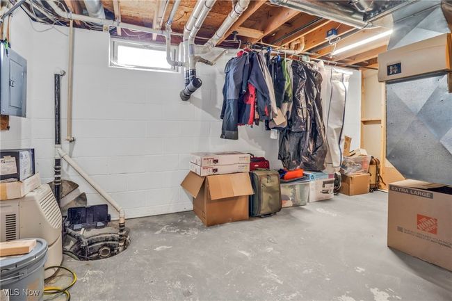 Below grade area featuring concrete block wall and electric panel | Image 32