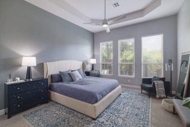 Bedroom featuring carpet flooring, baseboards, and ceiling fan | Image 16