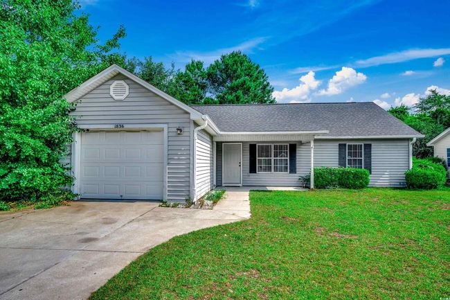Ranch-style home featuring driveway, a front yard, an attached garage, and a shingled roof | Image 38